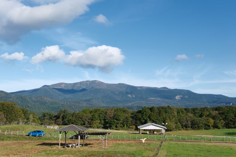 10月の栗駒山と牧場の風景